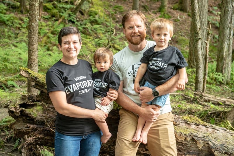smiling family in woods wearing vermont evaporator company tees