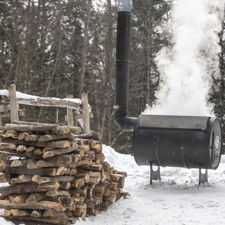 Maple Syrup Evaporator with Sugar Wood Stacked near by
