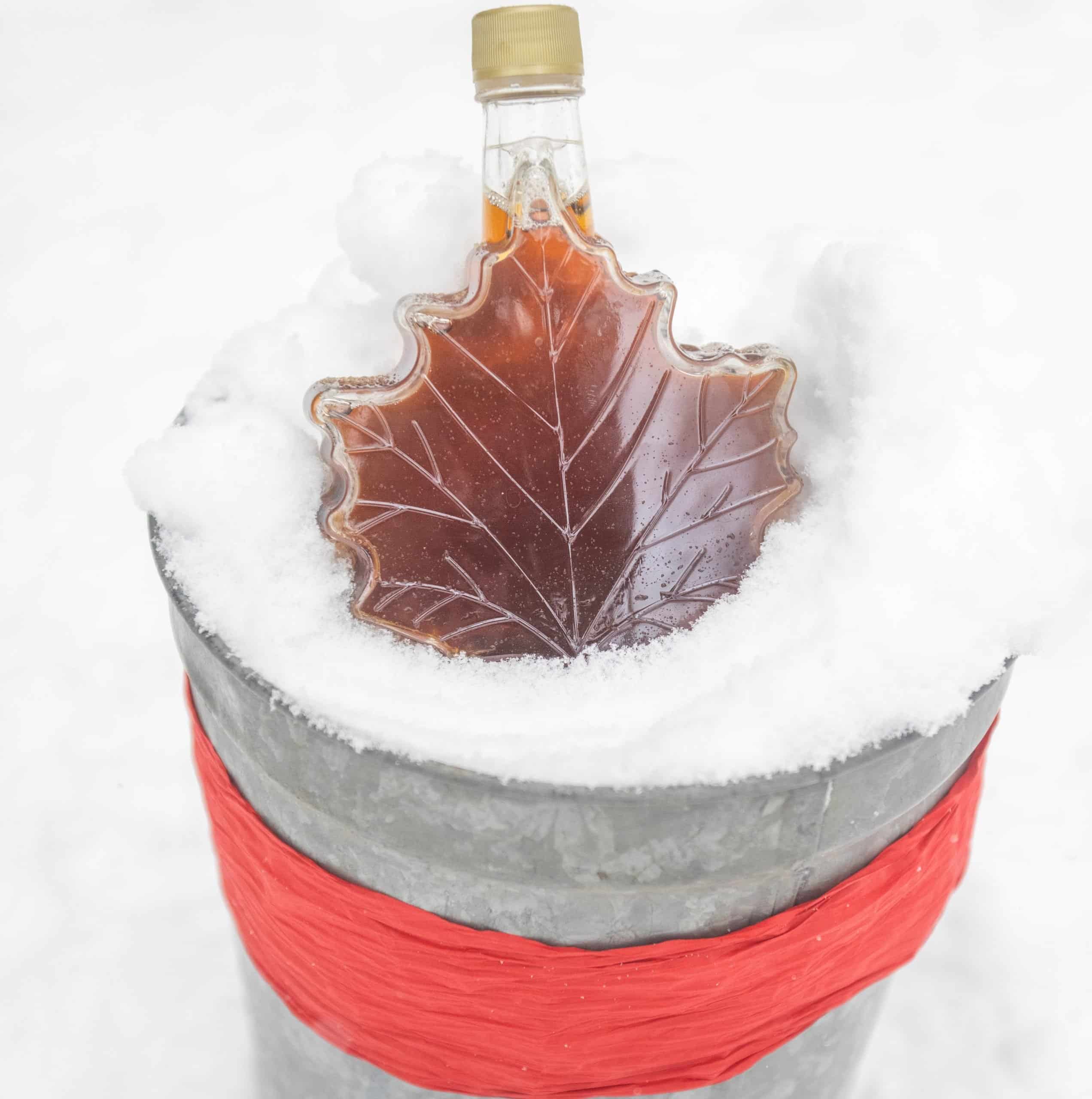 Maple Leaf Syrup Bottle filled with syrup in the snow