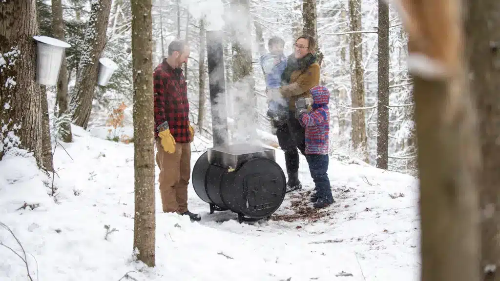 Family in the snow with an evaporator