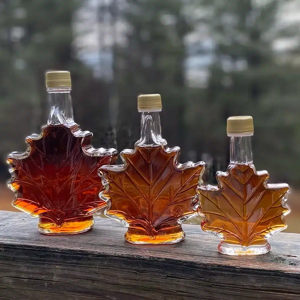 Maple leaf shaped bottles full of maple syrup