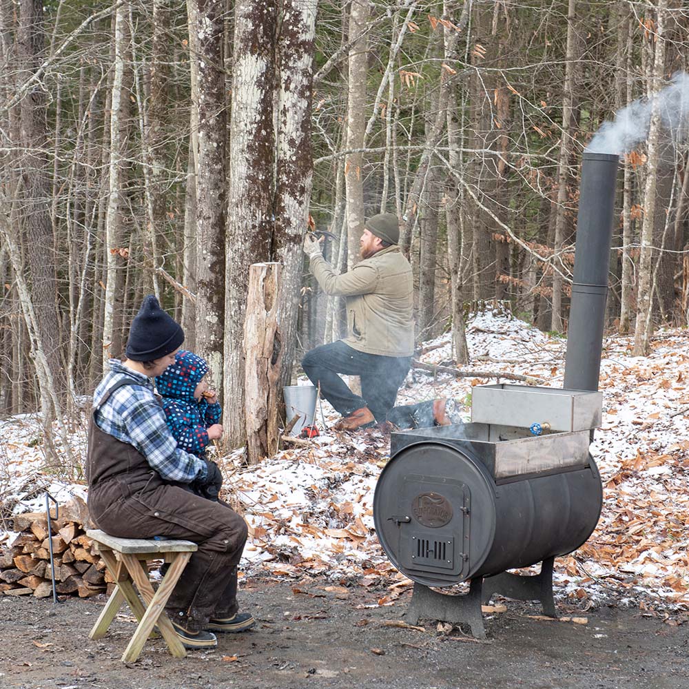 Family making maple syrup
