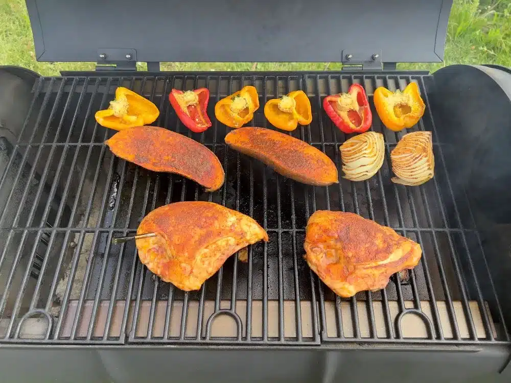 Chicken and veggies on a grill.