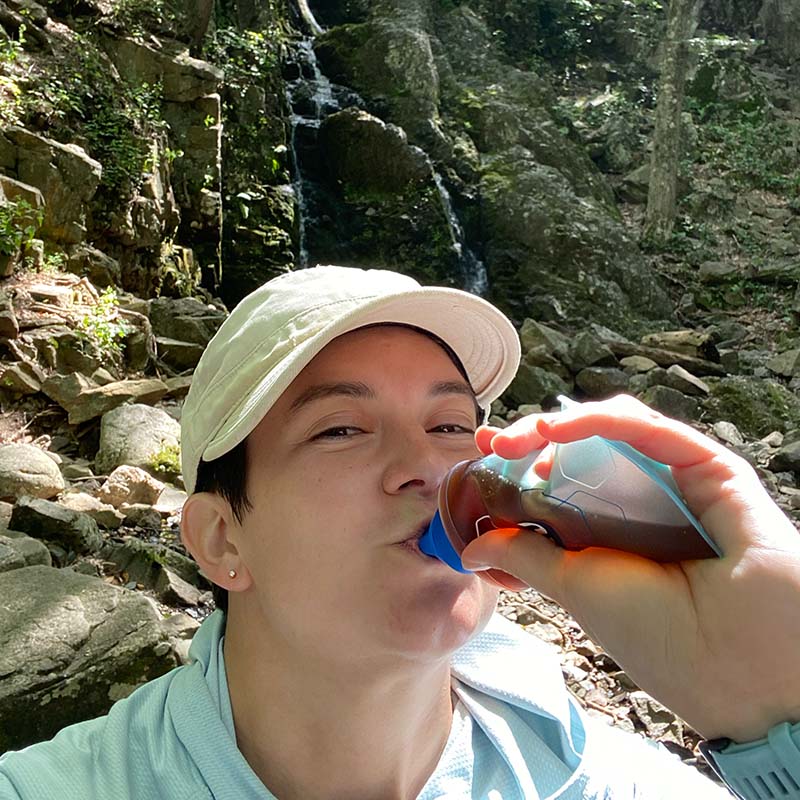 Hiker drinking maple syrup