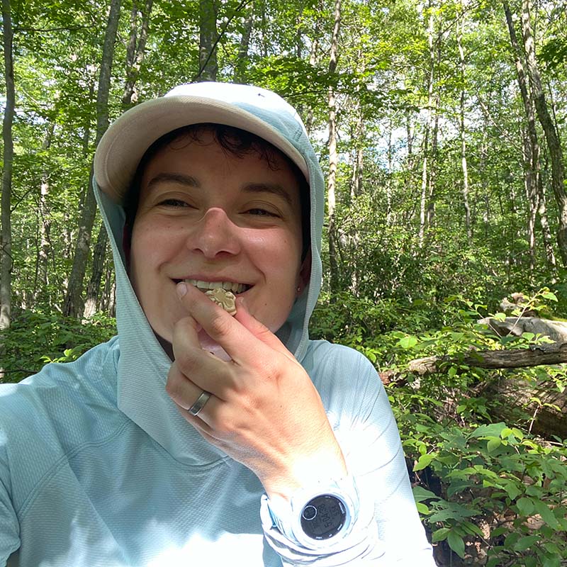 Person eating Maple candy while hiking