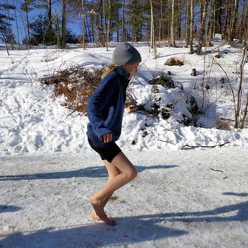 Kid playing on ice with no shoes
