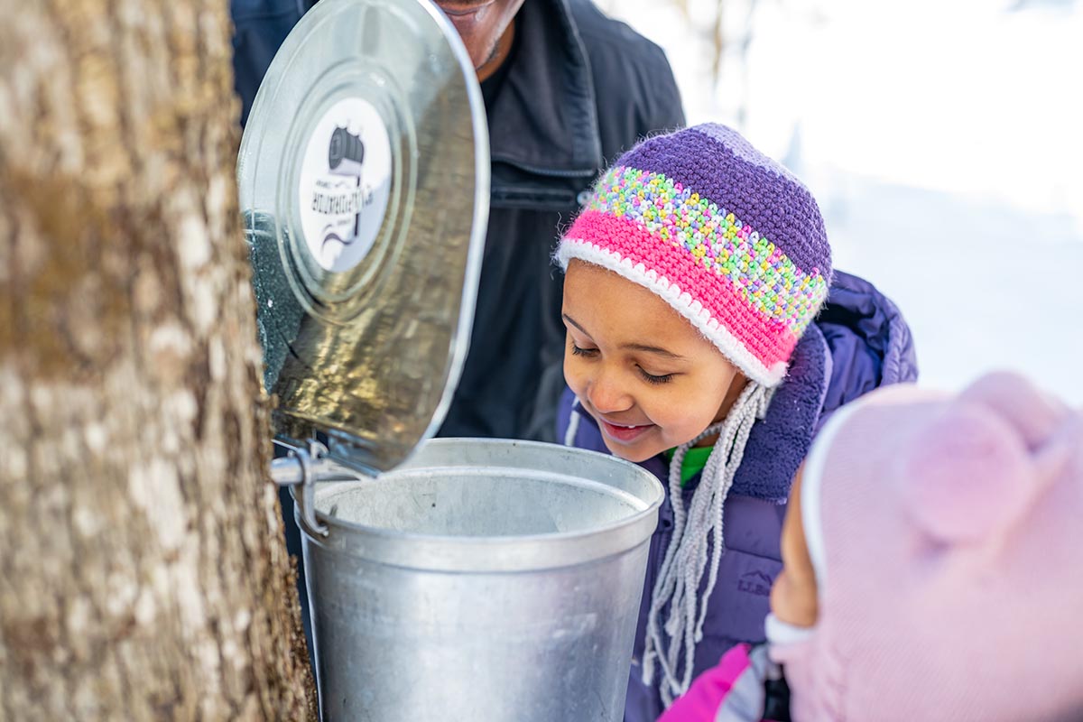 child pouring sap